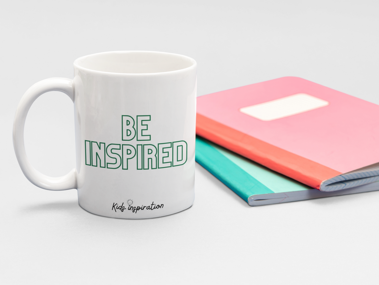 The back of the Everything is Roarsome mug says Be Inspired in green text to inspire kids